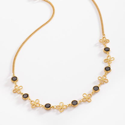 Collar en baño de oro con dijes elegantes y piedra negra